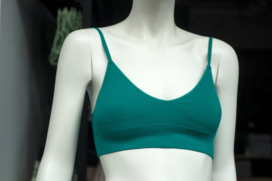Closeup of green fitness bra on mannequin in fashion store showroom