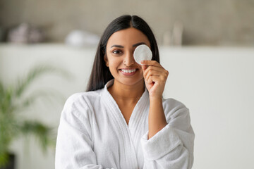 Pretty indian woman cover one eye with cotton pad © Prostock-studio