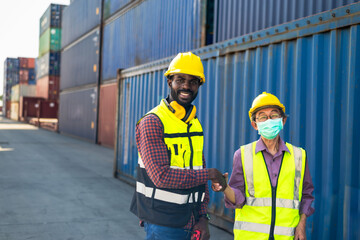 Diversity black man and senior Japanese man workers working together in container cargo warehouse