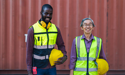 Black container worker man and Japanese colleague working in container shipping seaport