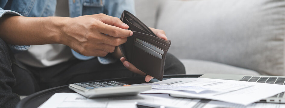 Debt financial concept, stressed problem people asian man, male hand open empty wallet not have budget of money to pay no have credit card, not able payment bill, loan or expense with bank, bankruptcy