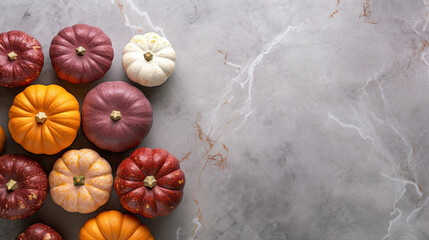 Obraz na płótnie Canvas A group of pumpkins on a light maroon color marble