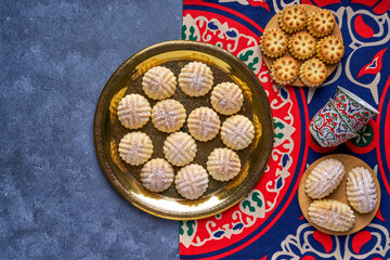 Top view of traditional arabic Eid-al-Adha, Eid -al-fFtr semolina maamoul cookies filled with dates, walnuts, and pistachios.
