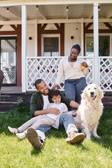 quality time, cheerful african american father and son playing near woman and dog on backyard