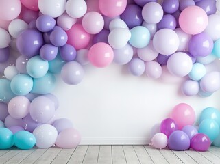 Fototapeta na wymiar Balloon decoration in purple, blue and pink against the background of a white wall with an empty space in the center