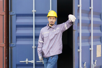 Asian male customs officer is currently conducting inspections of containers within the container...