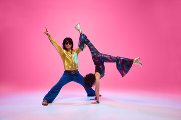 Energetic disco dance lift, couple in 1970s fashion outfit dancing in motion with playful energy...