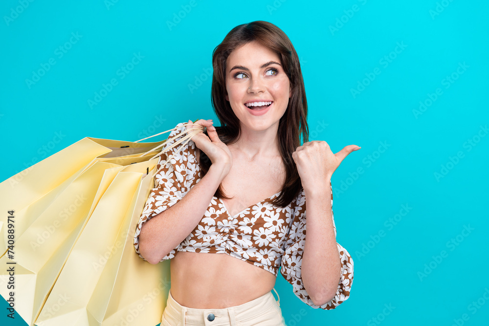 Canvas Prints Photo of shopaholic woman brunette charming wife recommend buy clothing here copyspace point finger isolated on cyan color background