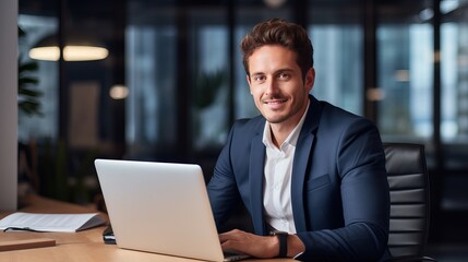 Fototapeta premium Portrait of young businessman working in office
