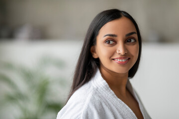 Closeup of beautiful indian woman wearing bathrobe at spa