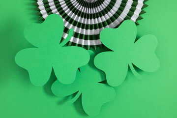 Celebration St. Patrick's day holiday on green background. Shamrock green, paper decorations. Saint...