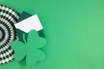 Celebration St. Patrick's day holiday on green background. Shamrock green, paper decorations. Saint...