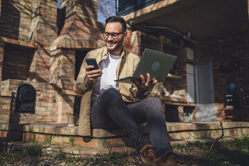 man caucasian male talk use mobile phone smart phone while sit outdoor