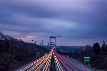Speed Traffic light trails on motorway highway at night, long exposure istanbul bridge background....