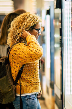 Young woman travel concept at self food and drink machine at the airport - passenger and boarding gate -  people and transporrt holiday - backpack traveler