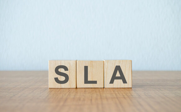 Three wooden cubes with letters SLA means Service Level Agreement