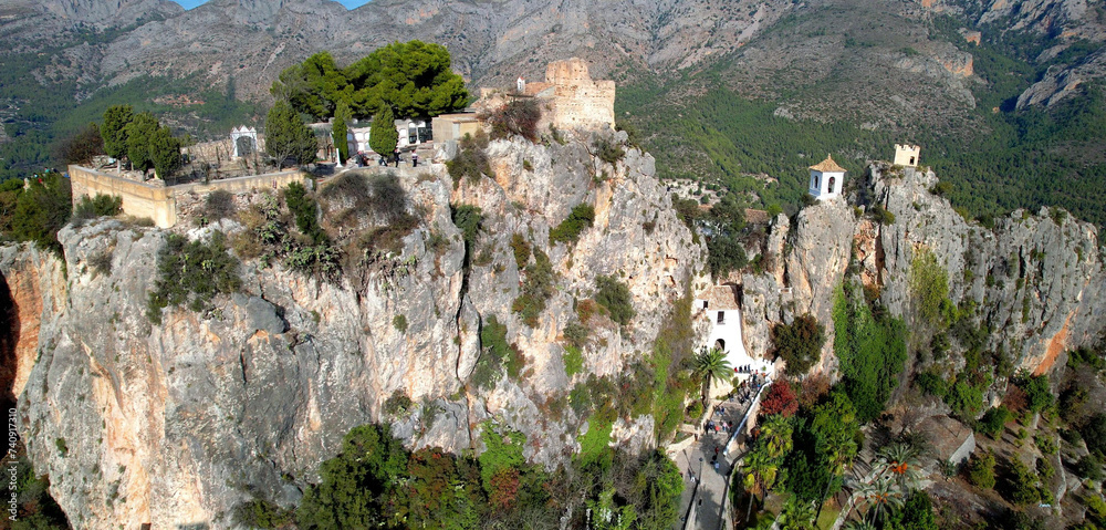 Wall mural landmarks of spain. medieval village guadalest, aerial drone view scenery with castle on the rocks a