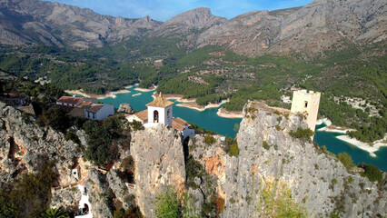 Landmarks of Spain. medieval village Guadalest, aerial drone view scenery with castle on the rocks and turquoise lake. Alicante province. - 740917354