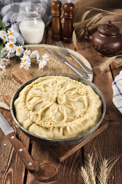 Tatar national pie balish semi-finished product on a wooden background