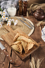 Tatar national pies triangles on a wooden background