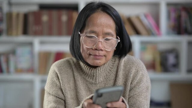 Portrait of Old Asian Woman Looking at Camera in home. Smiling Face and Beautiful Eyes of Happy.