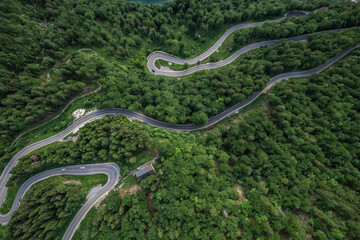 Curvy road in Slovenia Mountains, top down drone aerial view