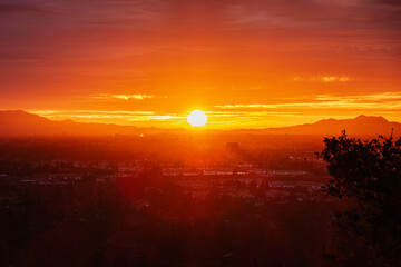 Los Angeles dawn sunshine bursting through layers of fog above the San Fernando Valley.  