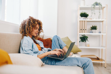 Smiling woman working on laptop and phone, enjoying freelance lifestyle in cozy home office