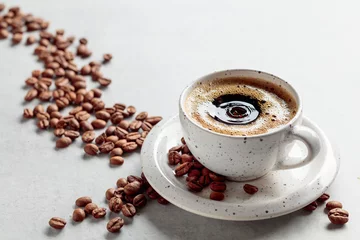  Black coffee and coffee beans on a white marble table. © Igor Normann