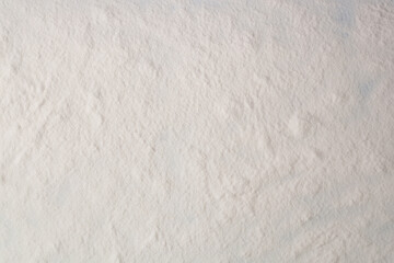 Flour texture. White flour on dark table. Baking background. Top view, copy space