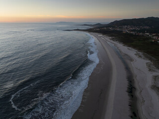 Aerial view of the Lariño lighthouse and Lariño beach at sunset