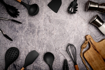 Kitchen silicone utensils for cooking tools on concrete background, top view, flat lay. Kitchenware...