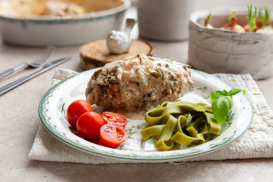 Traditional homemade Ukrainian meat cutlet zrazy with spinach tagliatelle paste