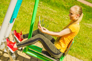 Girl doing exercises outdoor, taking selfie