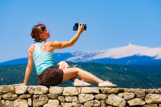 Woman take photo on mountain nature in France