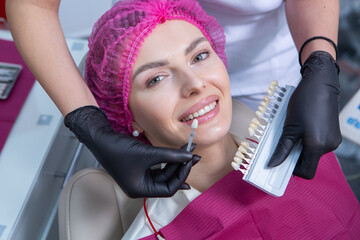 Dentist examining teeth of a young woman patient in a dental clinic. Dentistry concept. Dentist and patient in the dental office.