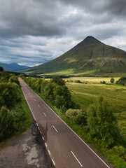 The A82 road passing through Bridge of Orchy in the Scottish highlands.