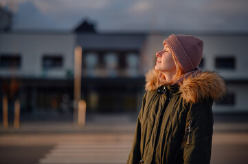 Contemplative Woman Enjoying Sunset in Urban Environment
