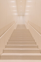 Stairs in a white corridor leading to the second floor