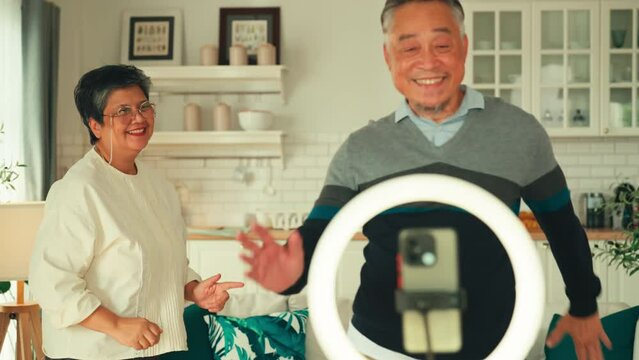 family tiktoker lives tiktok reel instagram funny dance with daughter teen in living room home background by smartphone gadget sharing experience lives video on social media application broadcast