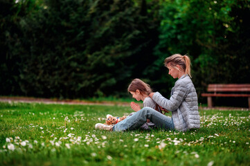 Tender moment between mother and daughter in a serene park setting
