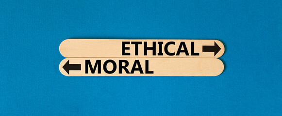 Ethical or moral symbol. Concept word Ethical or Moral on beautiful wooden stick. Beautiful blue...