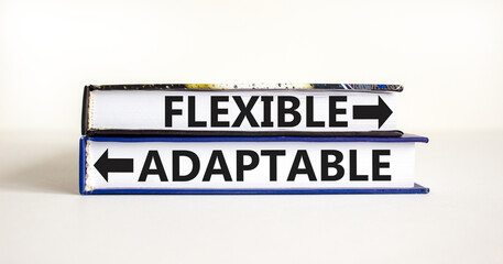 Flexible or adaptable symbol. Concept word Flexible Adaptable on beautiful books. Beautiful white...