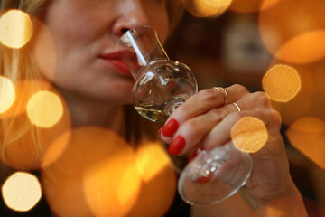 woman tastes wine at a wine tasting in a restaurant