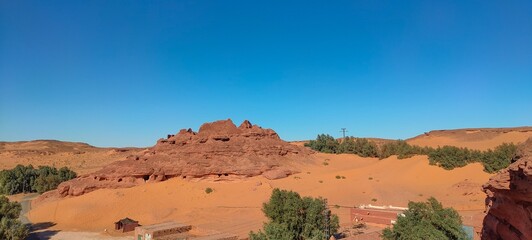the remains of Ksar d'Ighzer, ruins of ancient stone and red clay houses, a village in the middle of the desert in the town of Timimoun, Algeria
