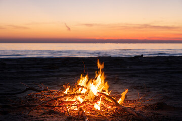 small fire in the beach with sunset sky - 740964312