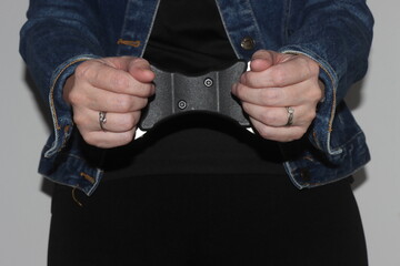 A close up of a woman's hands in handcuffs after she has been arrested. The woman is waiting to be...