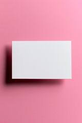 Minimalistic excellence in a white business card on pink background