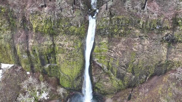 Horsetail falls flows over the rugged, mountainous landscape in the Columbia River Gorge separating the states of Oregon and Washington. The Pacific Northwest region has incredible outdoor scenery.