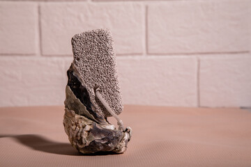 Pumice for foot massage with mussel shells on a light background